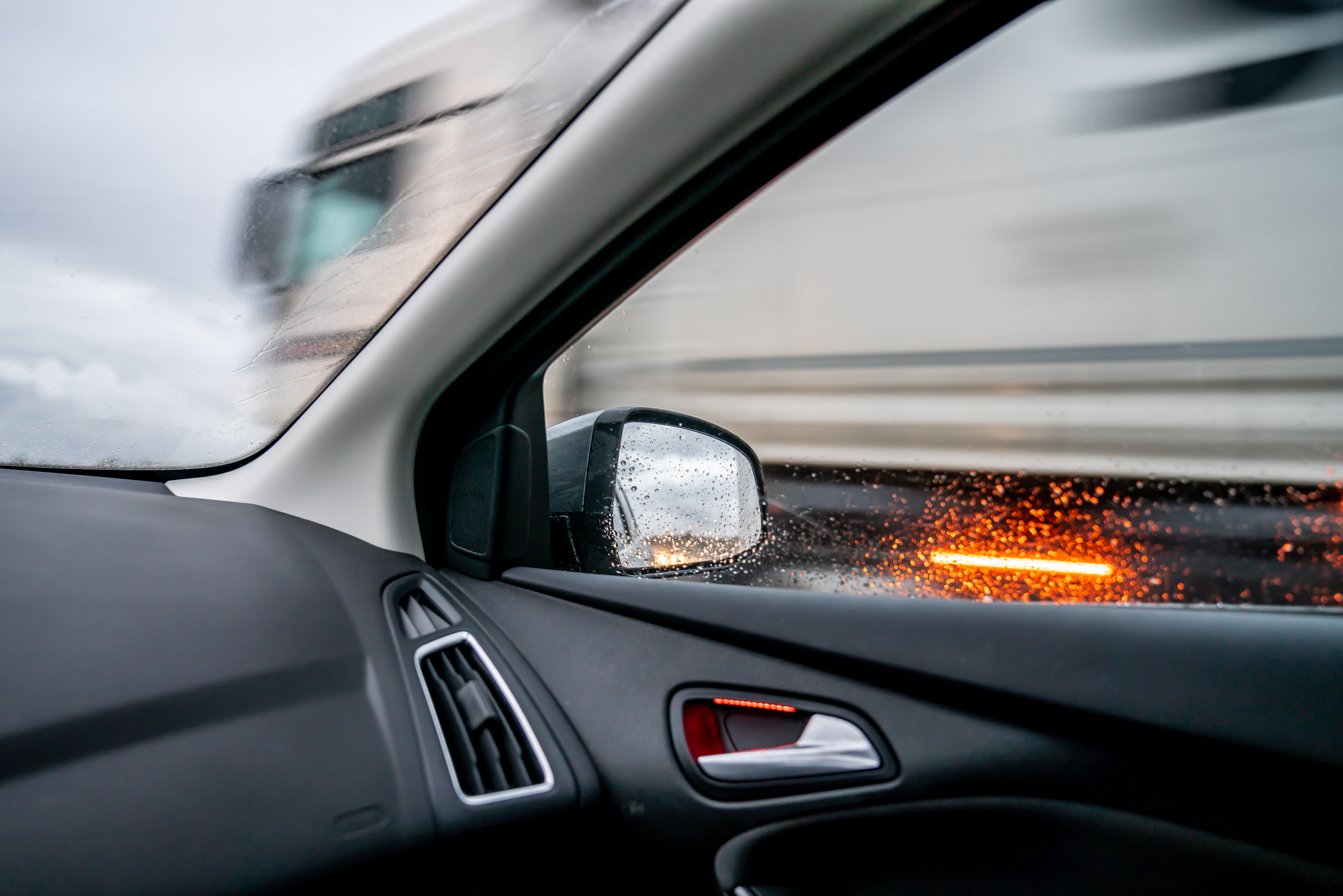 Truck overtaking car in the wet