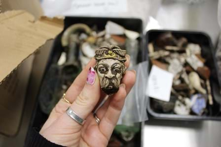 Clay pipe bowl in the shape of a face with a headdress