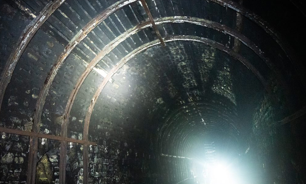 Interior of the tunnel with light illuminating the supporting structures