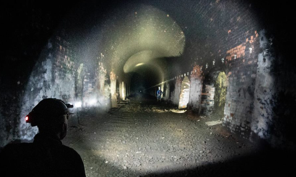 Helmet lights illuminate the tunnel