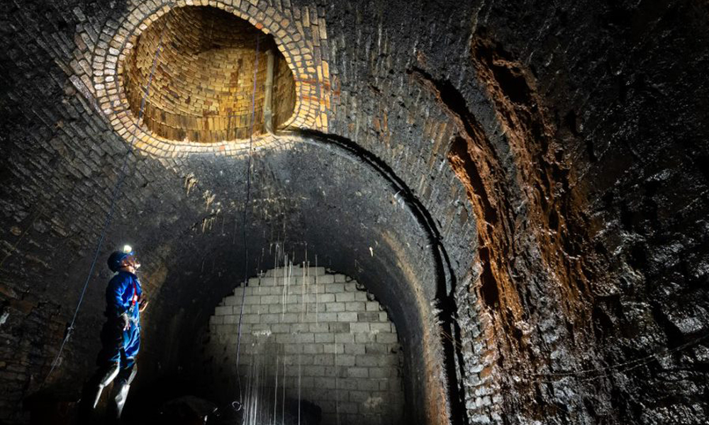 A volunteer inspects a tunnel shaft