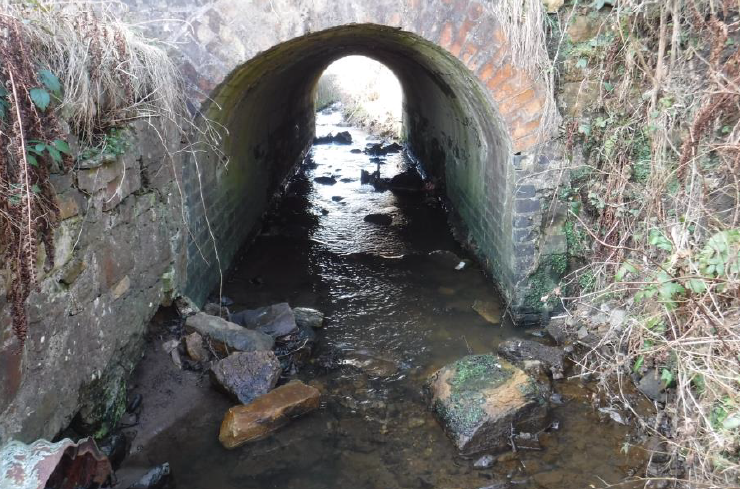 A small stream runs through a culvert under the north abutment.