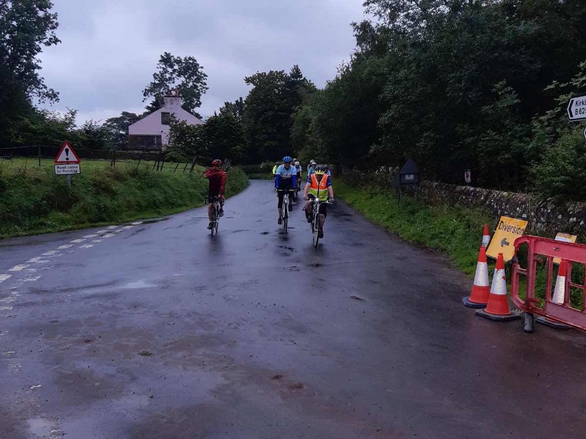 Cyclists taking part in local charity bike ride making their way over the bridge.