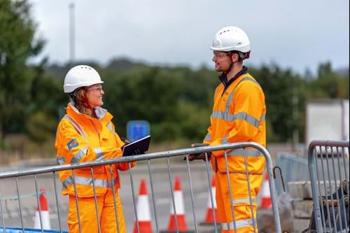 2 construction workers talking on site