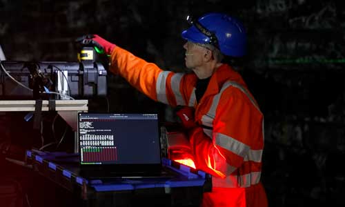 Worker using laser