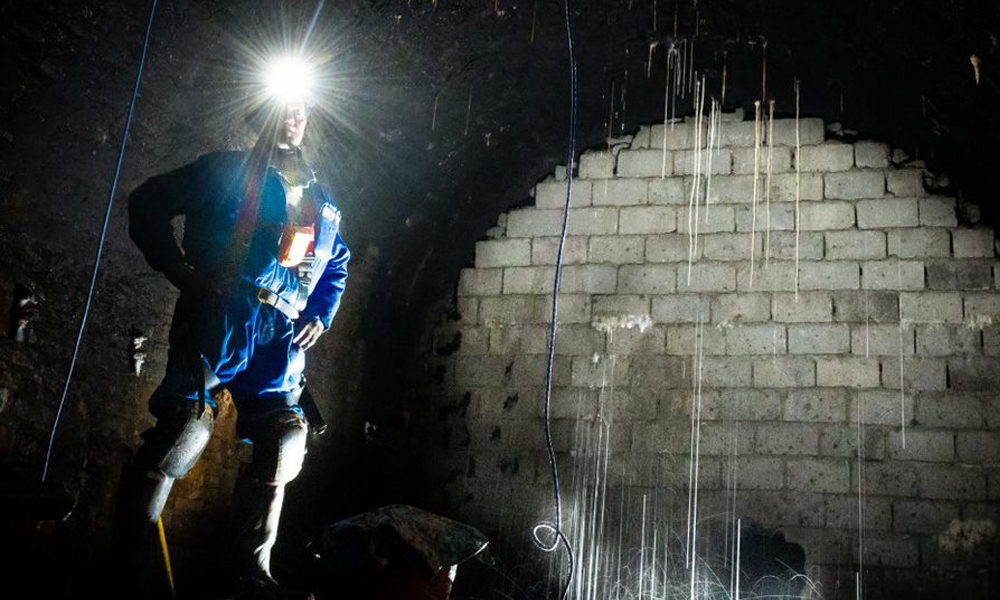 Inspection of the interior of the tunnel showing walled-off section and water ingress