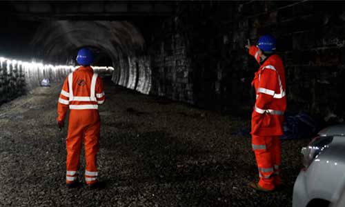 Workers discussing the tunnel structure