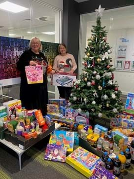 Donated toys under a Christmas tree