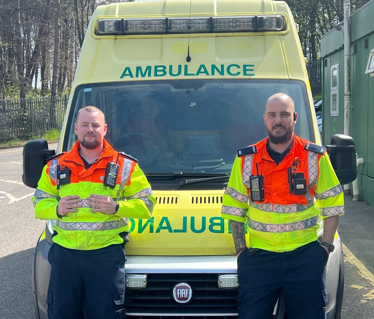 Tyler, left and Alex, with one of the ambulances which were taken to Ukraine