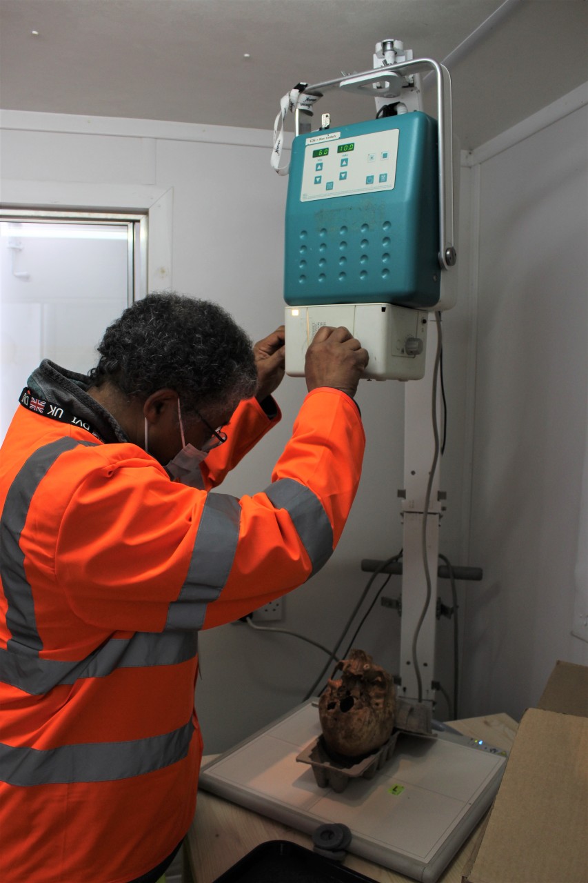 Wayne prepares the radiography machine and bones for x-ray