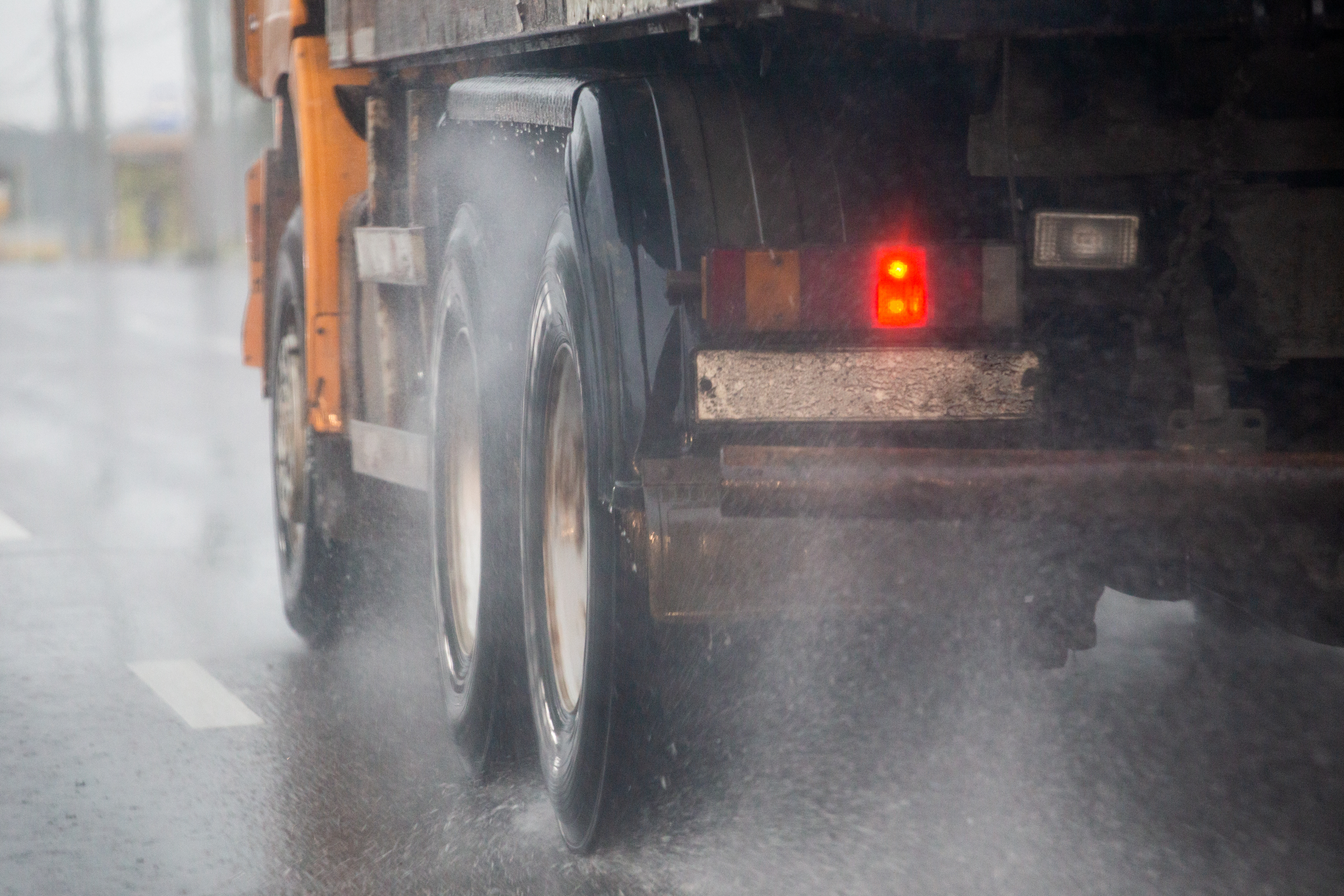 HGV in wet road conditions spry comming up from wheels