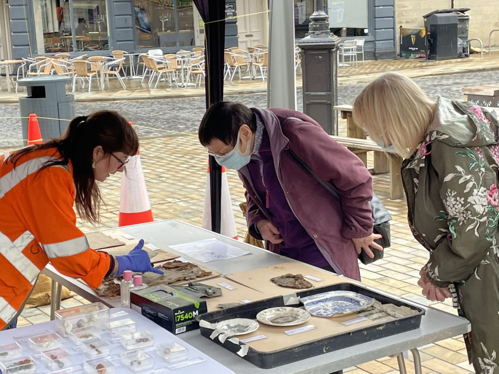 2 people looking at some of the findings at the Hull Archaeology Showcase Event