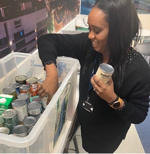 Leonie Stephen from National Highways helps pack a crate of donations from staff in Birmingham.