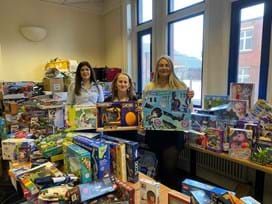 The team holding Christmas presents